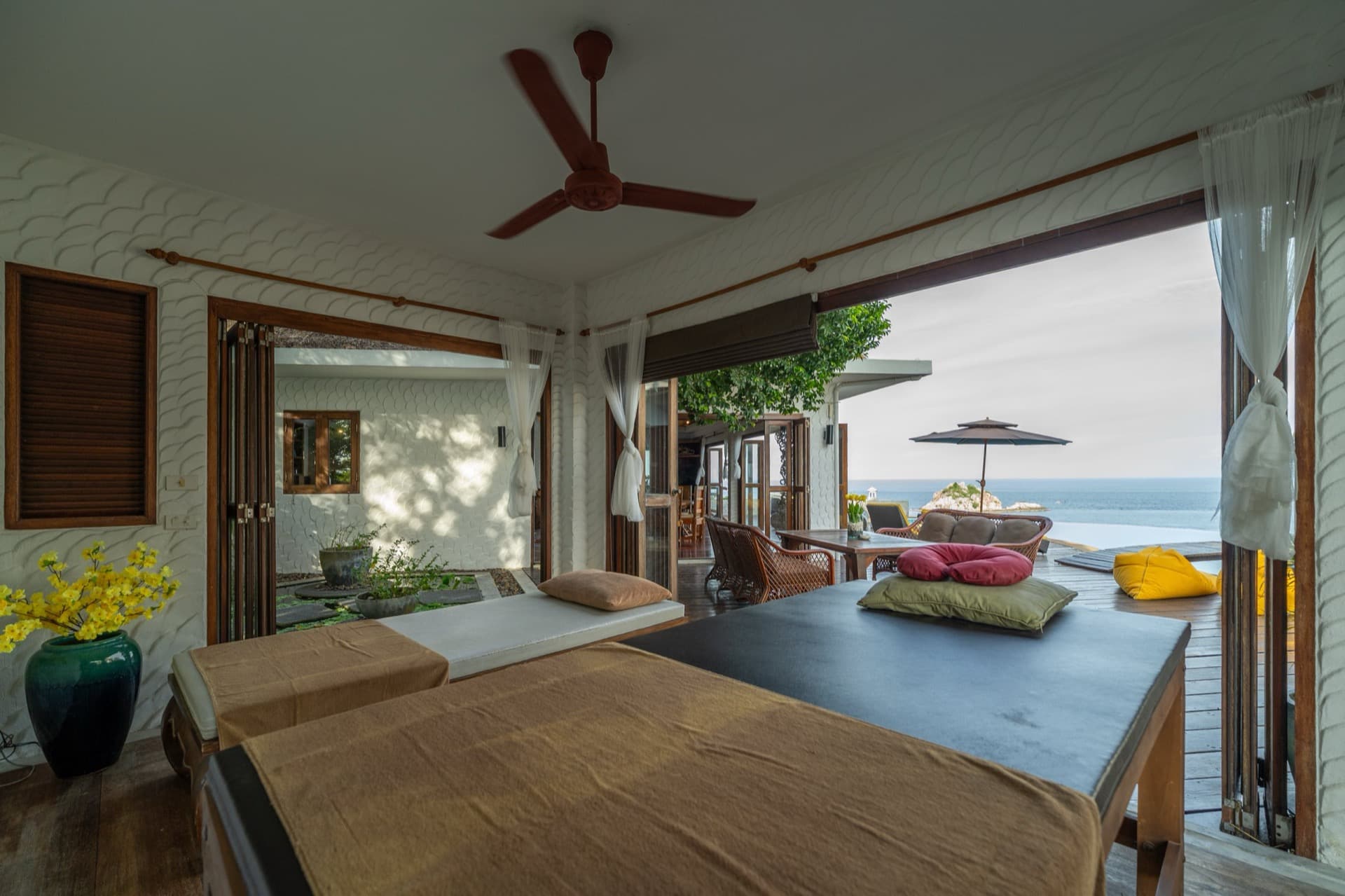 Open-air spa terrace at Villas Sabai Jai with massage beds facing the sea